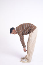 Load image into Gallery viewer, Man in striped sweater and beige ripstop cargo bending over
